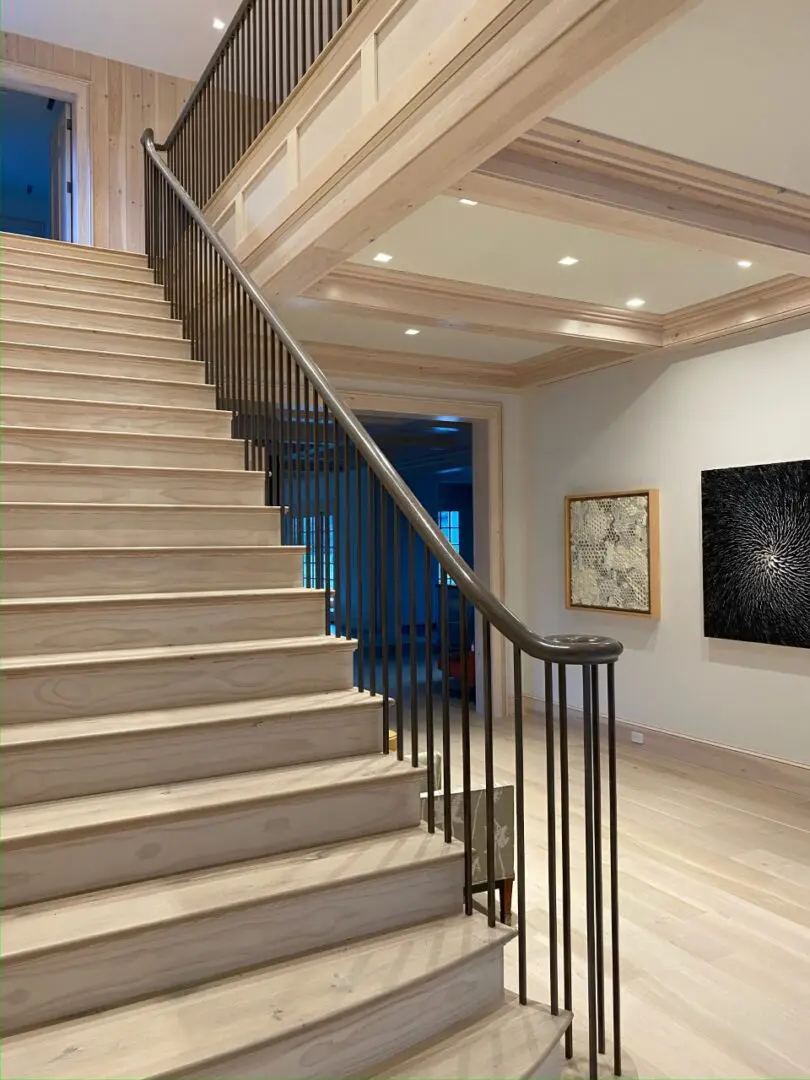 A staircase near a wall with paintings