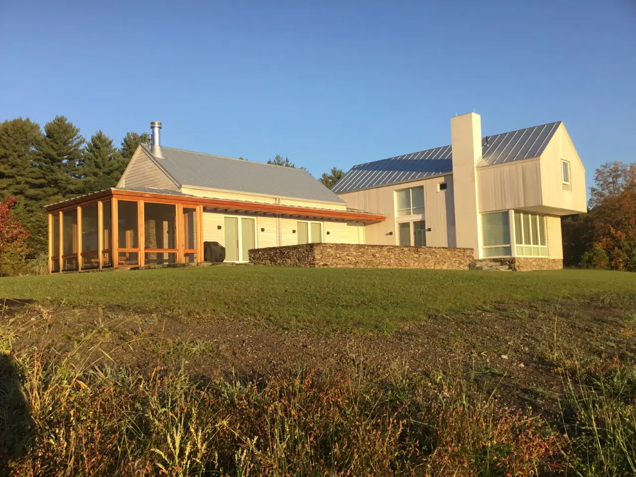 A house surrounded by green grass and trees